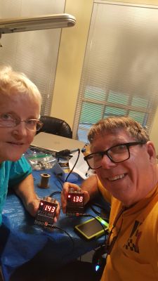 KO4EOR, Diane with her husband building Ultrasonic Ranging Alarm kits
